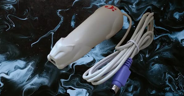 A white cat-shaped device resembling a computer mouse in size.